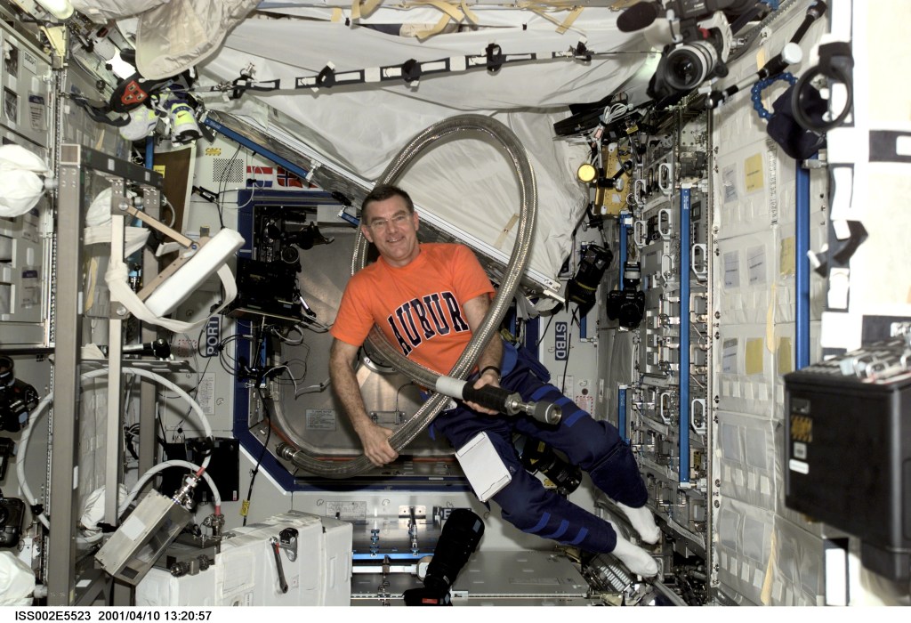 Astronaut James S. Voss, Expedition Two flight engineer, jokingly wraps a large hose around his body prior to installing it in the U.S. Laboratory / Destiny module of the International Space Station (ISS). This image was recorded with a digital still camera.