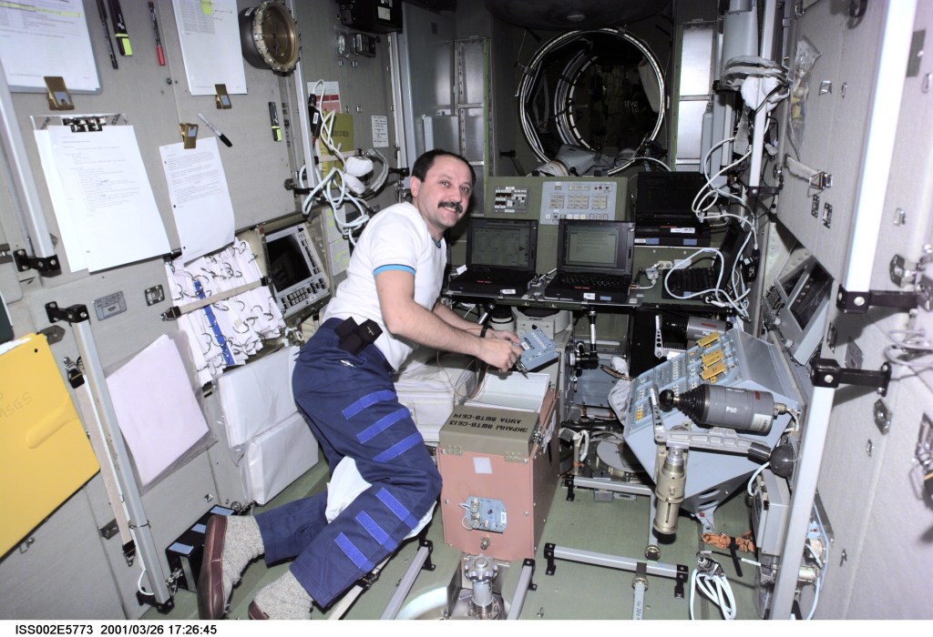 Yury V. Usachev of Rosaviakosmos, Expedtion Two mission commander, scribbles down some notes at the computer workstation in the Zvezda Service Module. The image was taken with a digital still camera.
