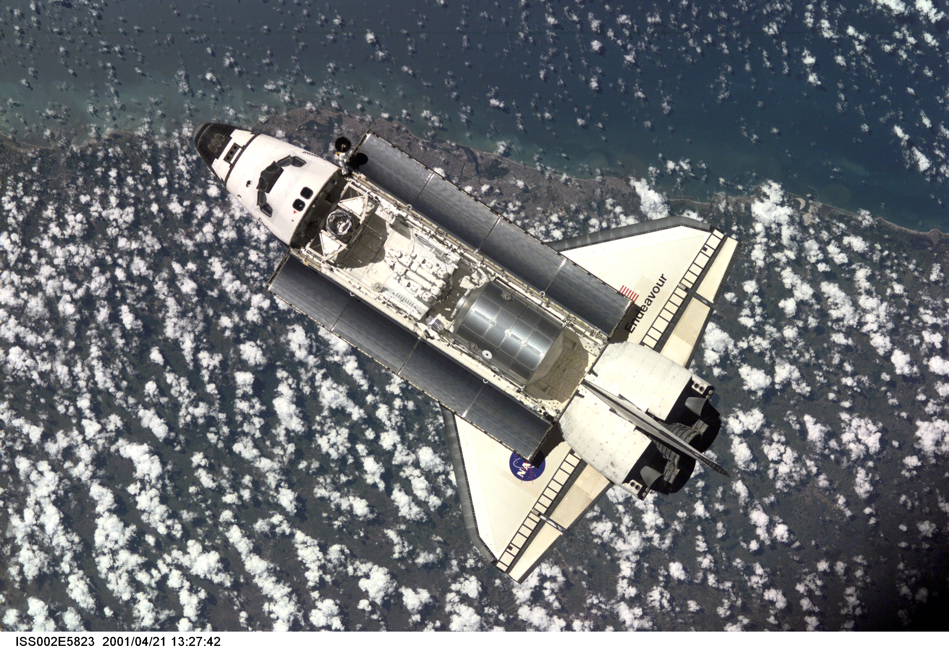 The Space Shuttle Endeavour, with six astronauts and a cosmonaut onboard, approaches the International Space Station (ISS) for an April 21 docking. The photo was taken with a digital still camera by one of the three Expedition Two crew members onboard the Station.