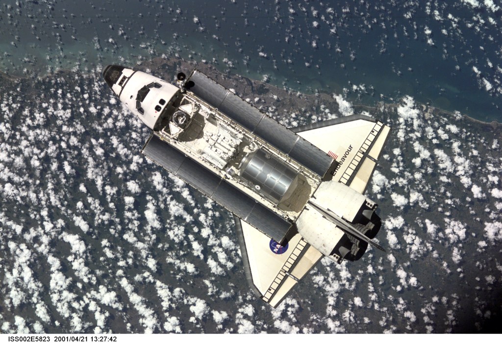 The Space Shuttle Endeavour, with six astronauts and a cosmonaut onboard, approaches the International Space Station (ISS) for an April 21 docking. The photo was taken with a digital still camera by one of the three Expedition Two crew members onboard the Station.