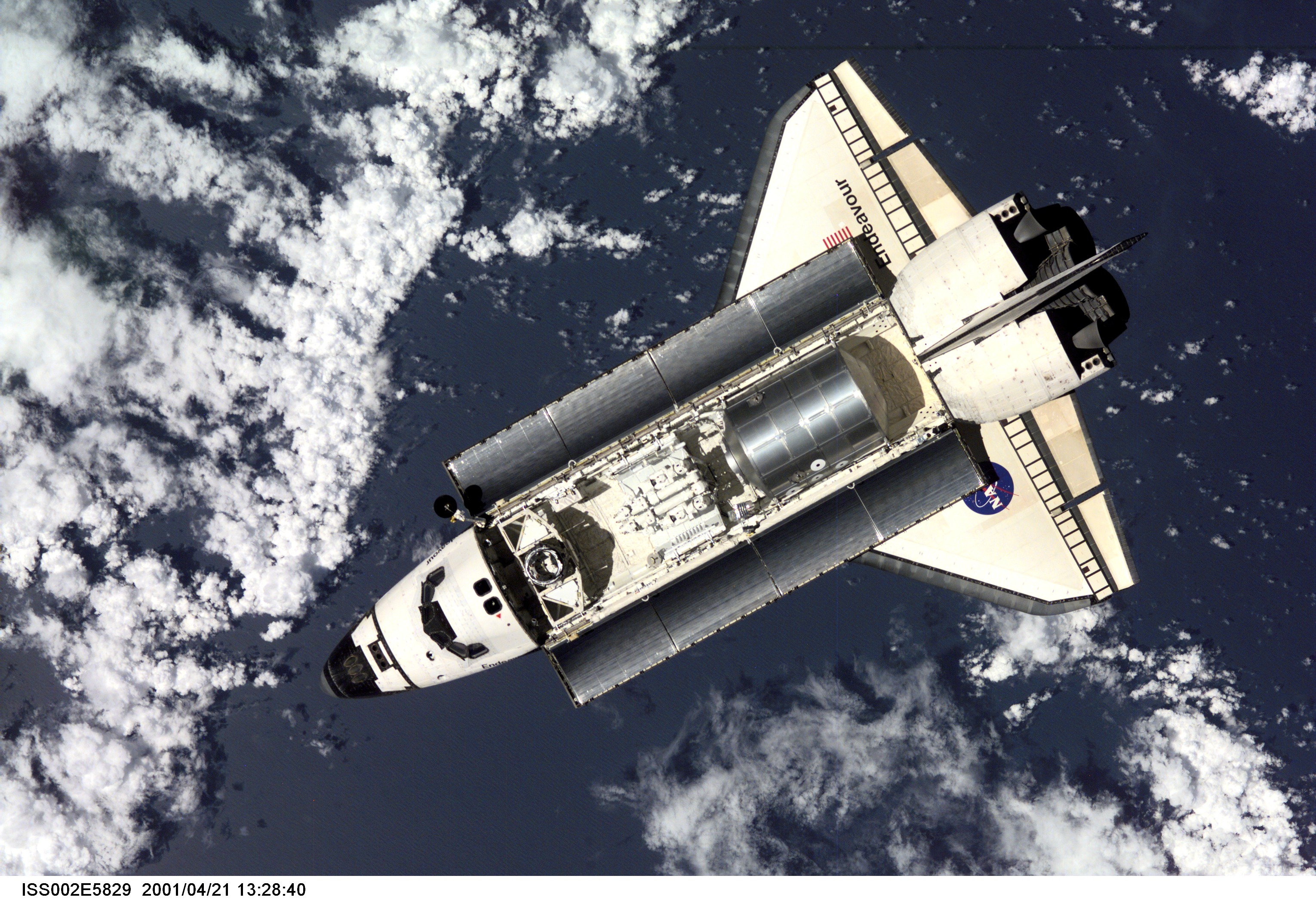 The Space Shuttle Endeavour, with six astronauts and a cosmonaut onboard, approaches the International Space Station (ISS) for an April 21 docking. The photo was taken with a digital still camera by one of the three Expedition Two crew members onboard the Station.