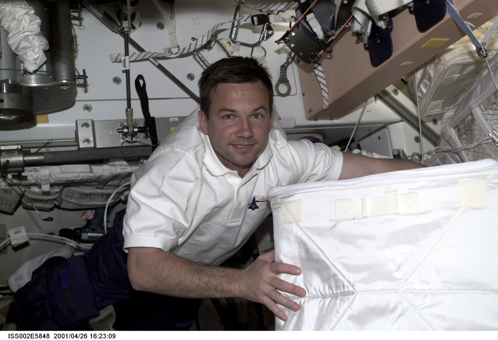 Yuri V. Lonchakov of Rosaviakosmos, STS-100 mission specialist, carries a stowage bag through Unity Node 1 during STS-100's visit to the International Space Station (ISS). The image was taken with a digital still camera.