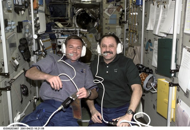 Two cosmonauts representing Rosaviakosmos, Yuri V. Lonchakov (left), STS-100 mission specialist, and Yury V. Usachev, Expedtion Two mission commander, communicate with mission control using headsets in the Zvezda Service Module during the STS-100 visit to the International Space Station (ISS). The image was taken with a digital still camera.
