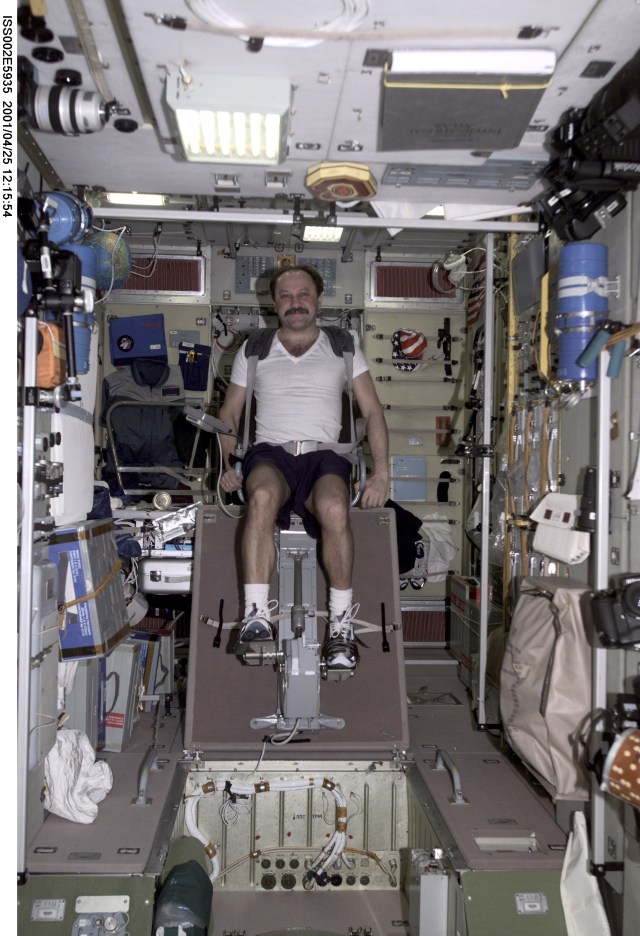 Yury V. Usachev of Rosaviakosmos, Expedition Two mission commander, exercises on the cycle ergometer in the Zvezda Service Module. The image was taken with a digital still camera.