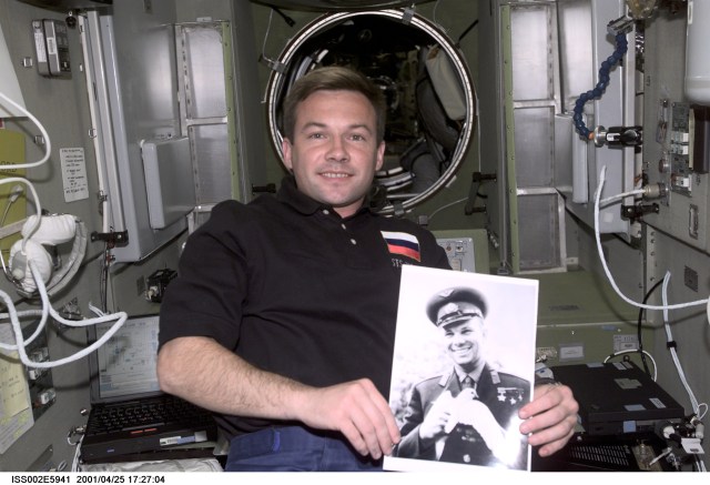Yuri V. Lonchakov of Rosaviakosmos, STS-100 mission specialist, holds a photograph of Yuri Gagarin in the Zvezda Service Module in commemoration of the anniversary of Gagarin becoming the first human in space. The image was taken with a digital still camera.