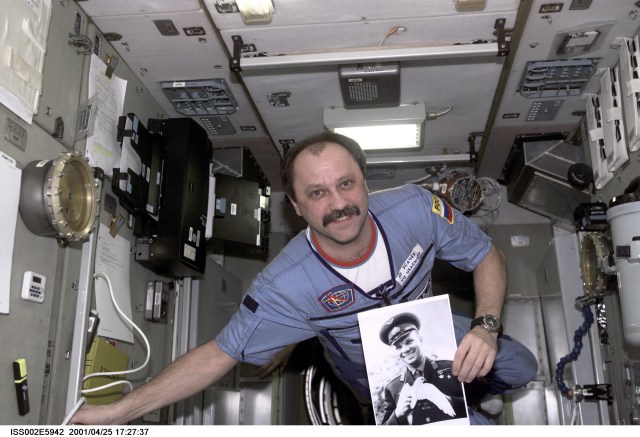 Yury V. Usachev of Rosaviakosmos, Expedition Two mission commander, holds a photograph of Yuri Gagarin in the Zvezda Service Module in commemoration of the anniversary of Gagarin becoming the first human in space. The image was taken with a digital still camera.