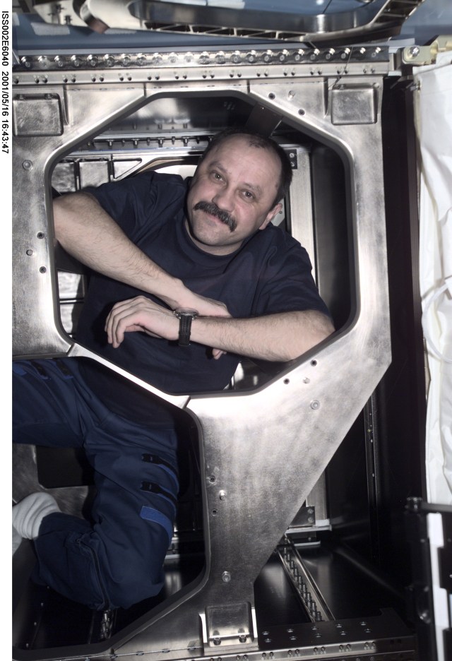 Yury V. Usachev of Rosaviakosmos, Expedition Two mission commander, poses in the area behind a removed panel in the U.S. Laboratory. The image was taken with a digital still camera.