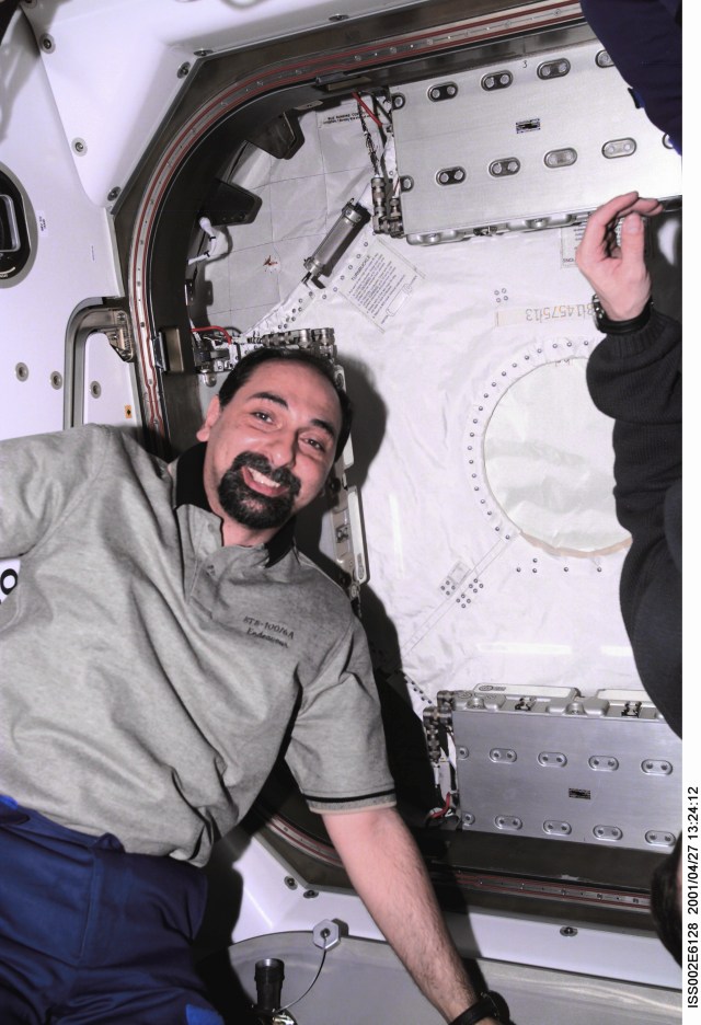 Umberto Guidoni of the European Space Agency (ESA), STS-100 mission specialist, poses for a photograph in Unity Node 1 as the hatch to the Multipurpose Logistics Module (MPLM) Raphaello is being closed near the end of the STS-100 mission. The image was taken with a digital still camera.
