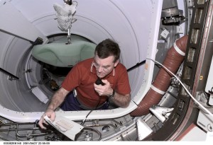 James S. Voss, Expedition Two flight engineer, discusses procedures with Mission Control while working in Pressurized Mating Adapter 2 (PMA2). The image was taken with a digital still camera.