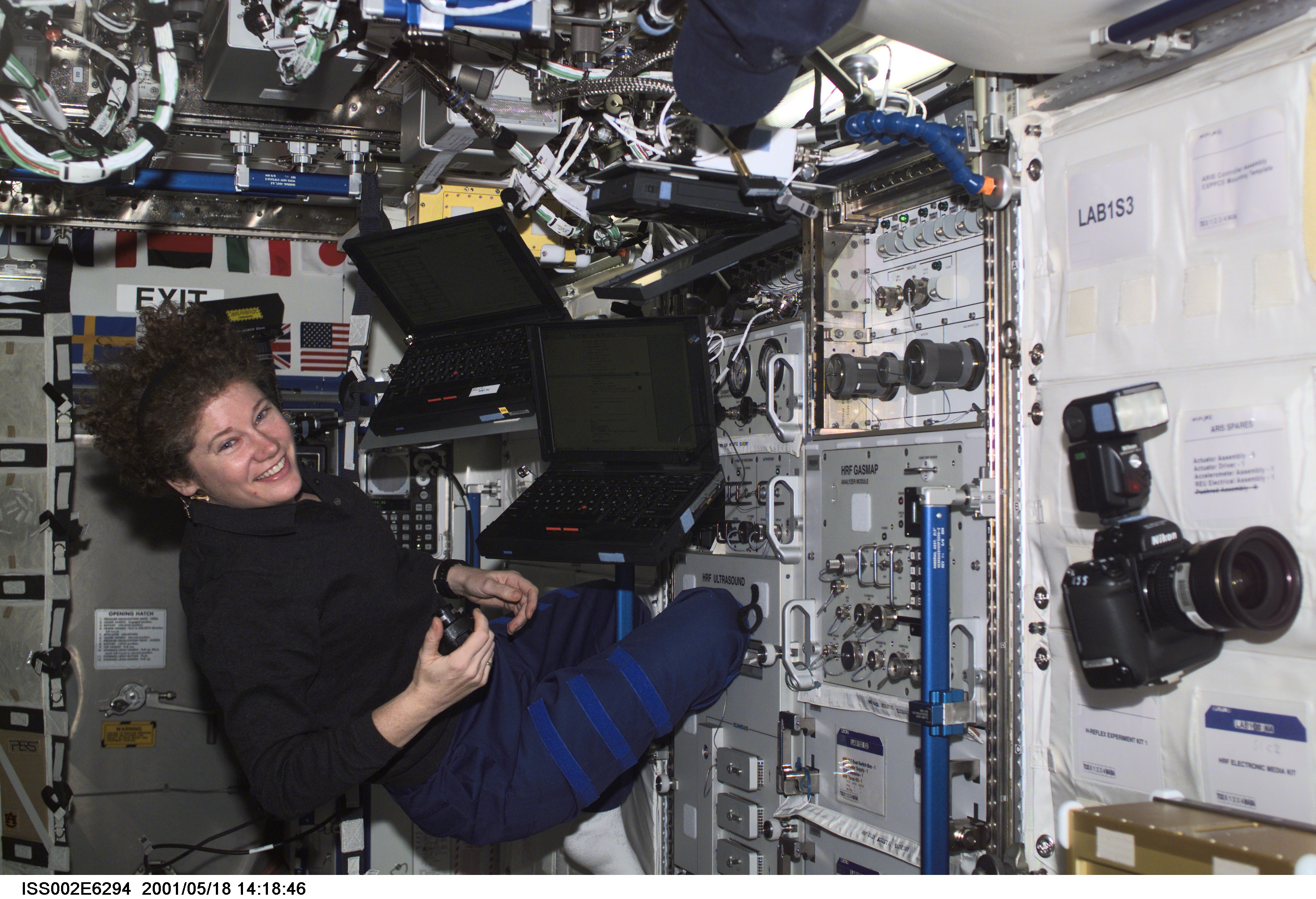Susan J. Helms, Expedition Two flight engineer, works with three laptop computers at the Human Research Facility (HRF) in the U.S. Laboratory. The image was taken with a digital still camera.