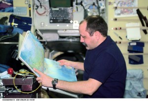 Yury V. Usachev of Rosaviakosmos, Expedition Two mission commander, looks over an atlas in the Zvezda Service Module. The image was taken with a digital still camera.