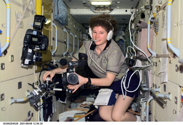 Astronaut Susan J. Helms, Expedition Two flight engineer, mounts a video camera onto a bracket in the Zarya or Functional Cargo Block (FGB) of the International Space Station (ISS). The image was recorded with a digital still camera.