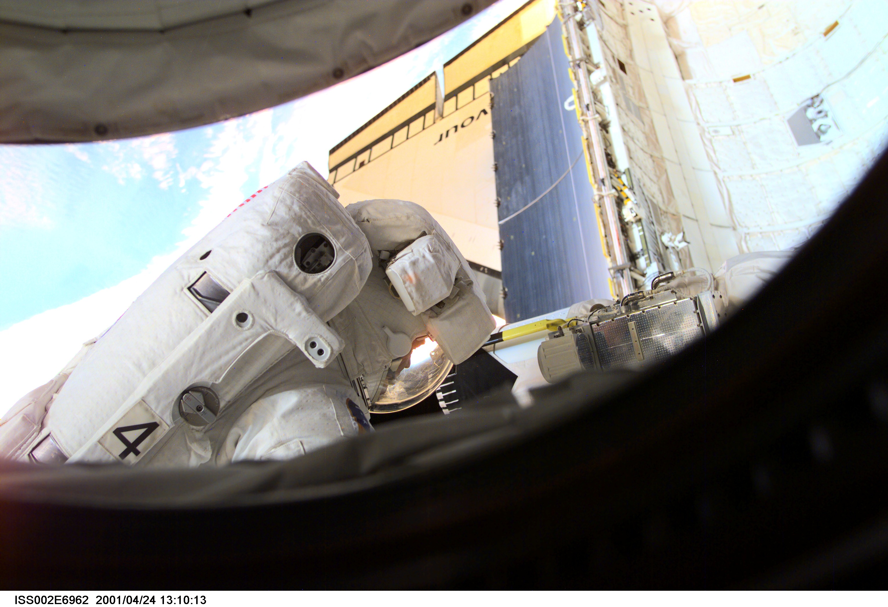 Astronaut Scott E. Parazynski, STS-100 mission specialist, performs a task during the second space walk (EVA-2). A digital still camera on the International Space Station (ISS) was used to record this image.