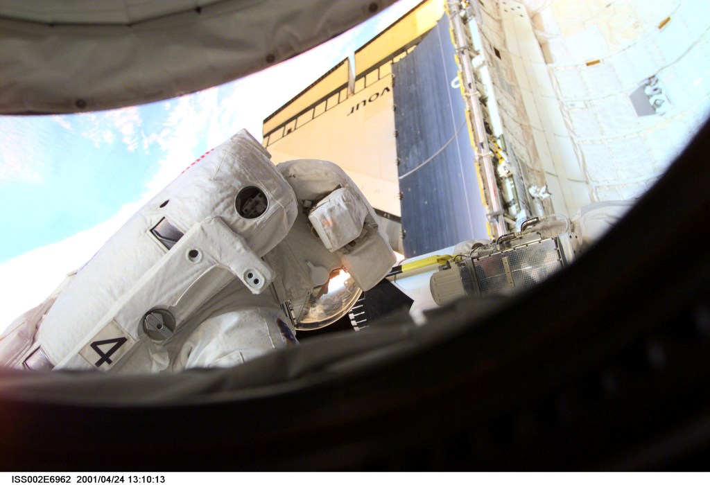 Astronaut Scott E. Parazynski, STS-100 mission specialist, performs a task during the second space walk (EVA-2). A digital still camera on the International Space Station (ISS) was used to record this image.