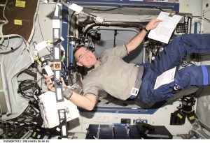 Astronaut James S. Voss, Expedition Two flight engineer, handles a connector in the Destiny/U.S. Laboratory. A digital still camera was used to record this image.