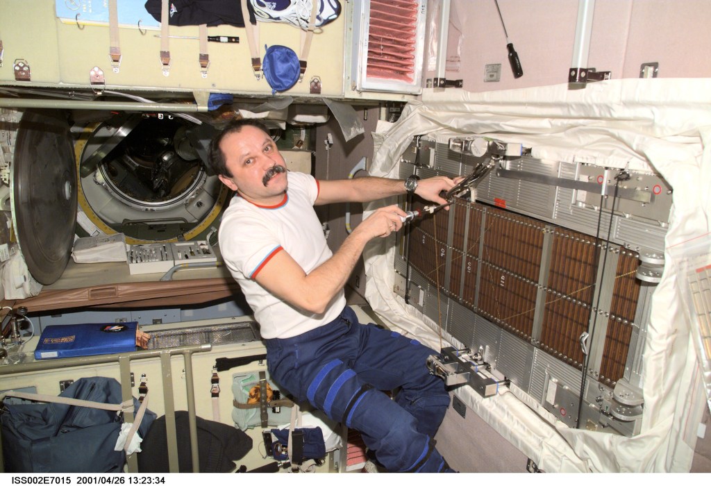 Cosmonaut Yury V. Usachev, Expedition Two commander representing Rosaviakosmos, conducts maintenance on the Treadmill Vibration Isolation System (TVIS) in the Zvezda/Service Module. A digital still camera was used to record this image.
