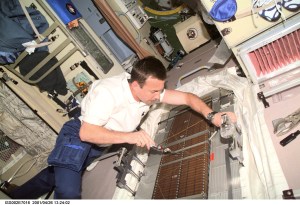 ISS002-E-7016 (26 April 2001) --- Cosmonaut Yuri V. Lonchakov, STS-100 mission specialist representing Rosaviakosmos, conducts maintenance on the Treadmill Vibration Isolation System (TVIS) in the Zvezda/Service Module. A digital still camera was used to record this image.