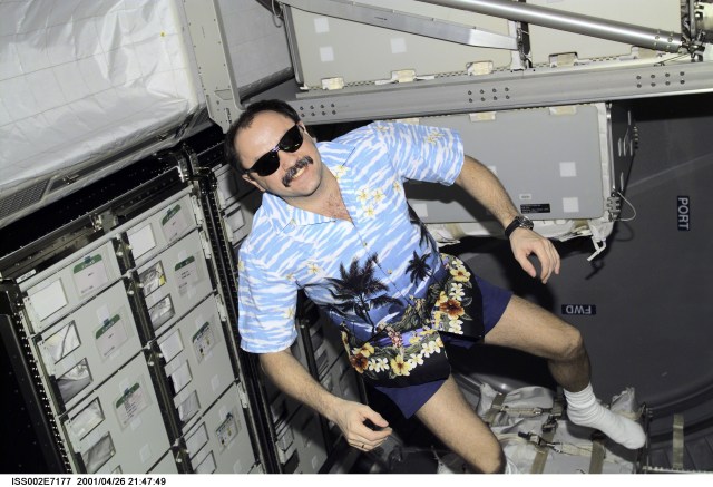 Rosaviakosmos cosmonaut Yury V. Usachev, Expedition Two commander, currently hosting six astronauts and a cosmonaut from the Endeavour's STS-100 mission, joins in the dress mode of the day--Hawaiian shirt and sunshades--as he pitches in to help in the moving process. He is in the recently-docked Italian-built Raffaello Multi-Purpose Logistics Module, which will return to Earth with the shuttle. The photo was recorded with a digital still camera.