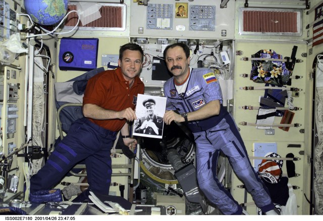 Celebrating the recent 40th anniversary of the first human-tended space flight, Rosaviakosmos cosmonauts Yuri V. Lonchakov and Yury V. Usachev hold a photo of the late cosmonaut Yuri Gagarin. The STS-100 mission specialist and the Expedition Two commander are in the Zvezda Service Module on the International Space Station (ISS). Usachev and two Americans are currently hosting Lonchakov and six astronauts as work continues on the orbiting outpost. The photo was taken with a digital still camera.