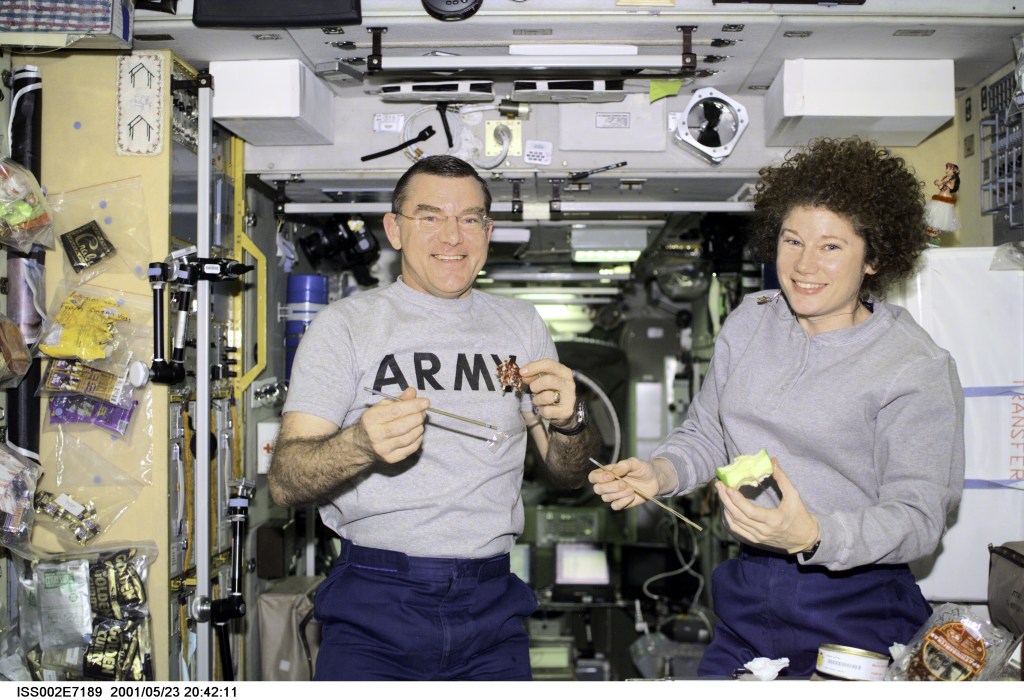 Astronauts James S. Voss and Susan J. Helms take a snack break in the Zvezda Service Module. The Expedition Two flight engineers were captured with a digital still camera by Rosaviakosmos cosmonaut Yury V. Usachev, commander.
