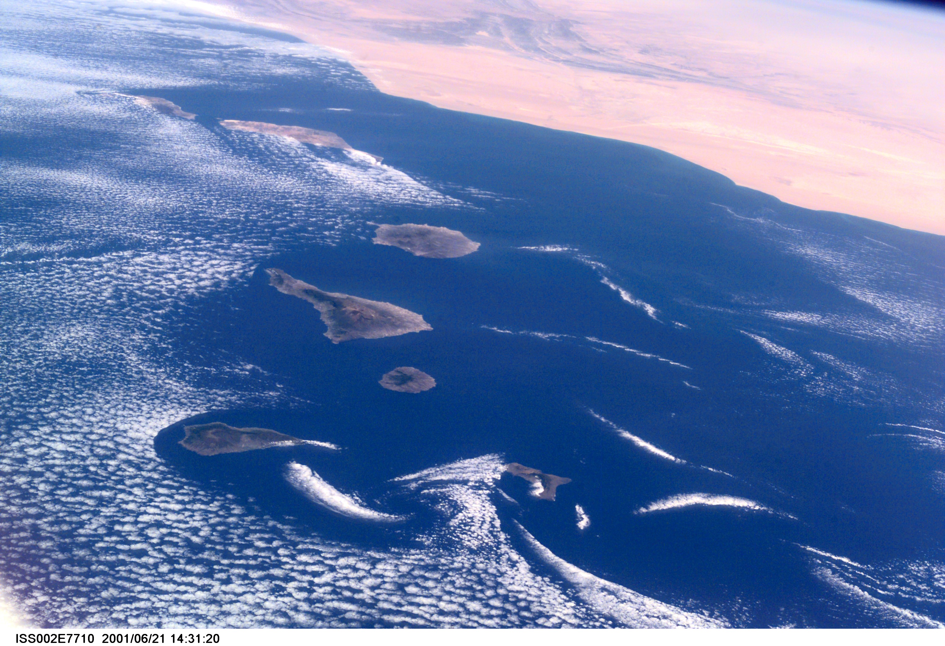 Commonly visible cloud vortices hover in the area of the Canary Islands off the coast of Morocco in this Expedition Two digital still camera's view from the International Space Station (ISS).