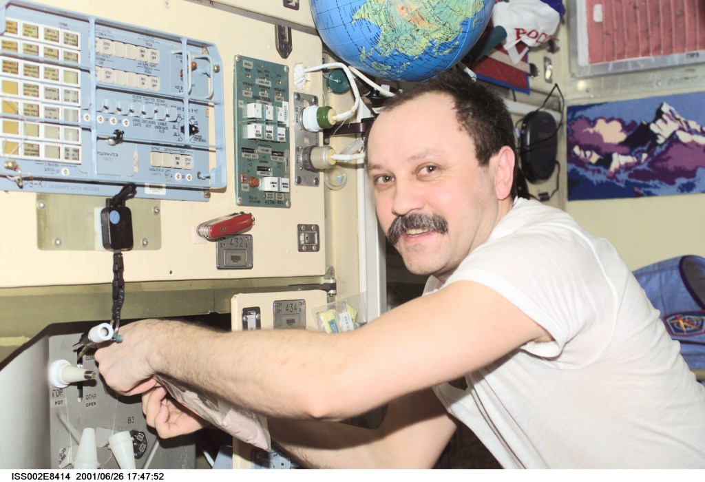 Yury V. Usachev of Rosaviakosmos, Expedition Two mission commander, fills up a bag of water in the Zvezda Service Module. The image was taken with a digital still camera.
