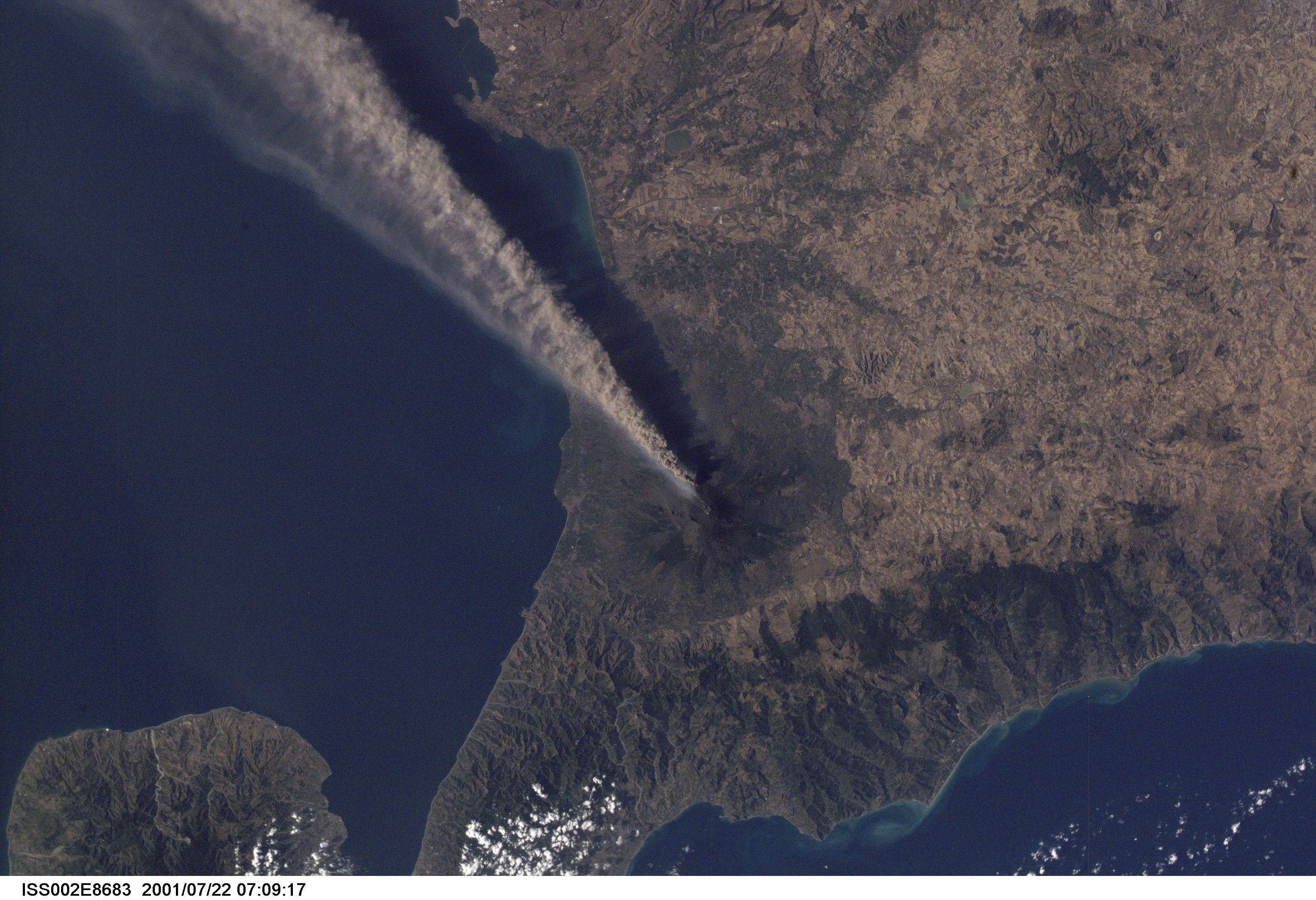 Smoke and ash combine to create a plume extending from the erupting volcano on Mt. Etna in Sicily. The digital still image was recorded by one of the Expedition Two crew members.