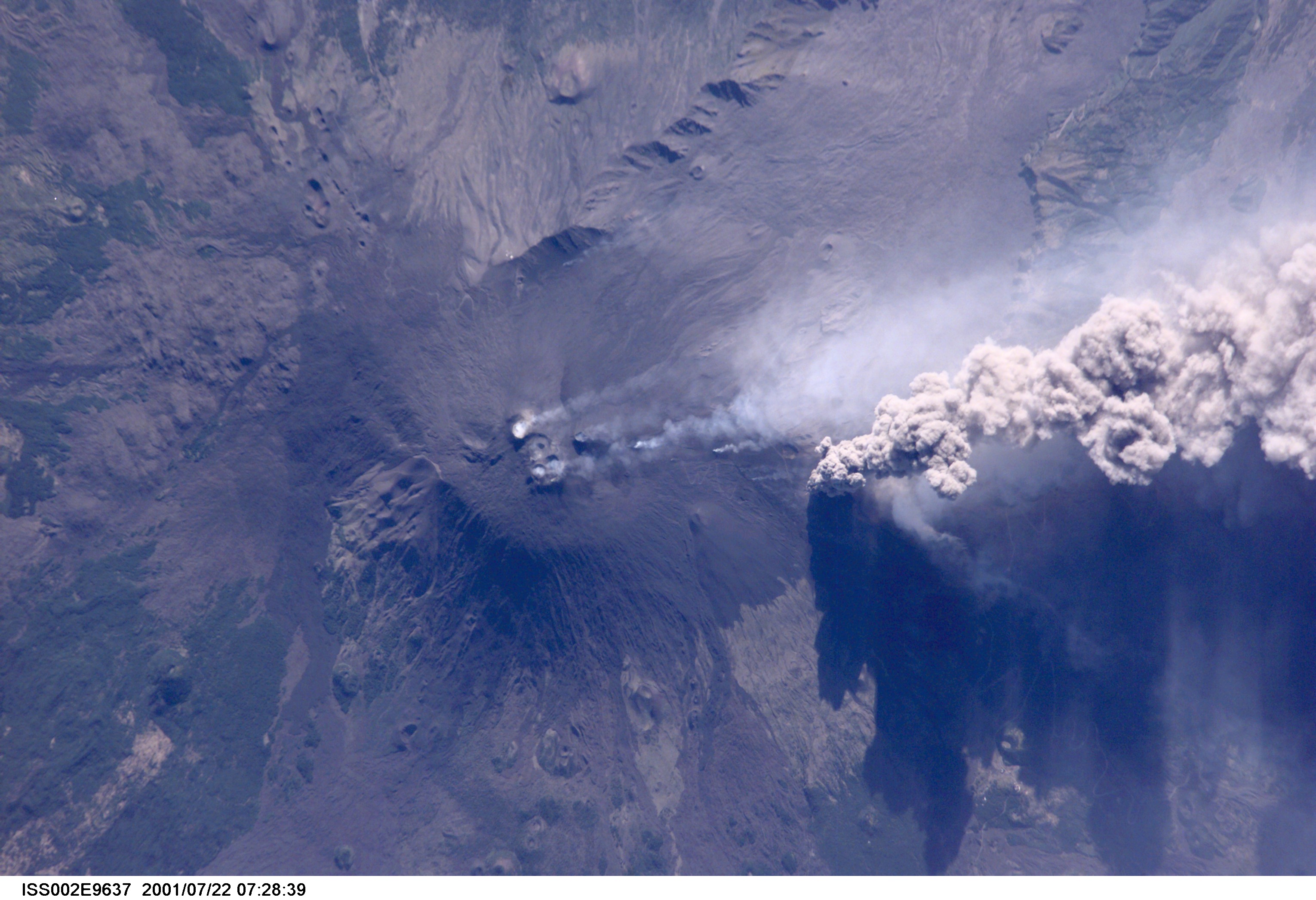 An overhead look at the smoke and ash being expelled from the erupting volcano Mt. Etna on the island of Sicily. This image was recorded by an Expedition Two crew member with a digital still camera.