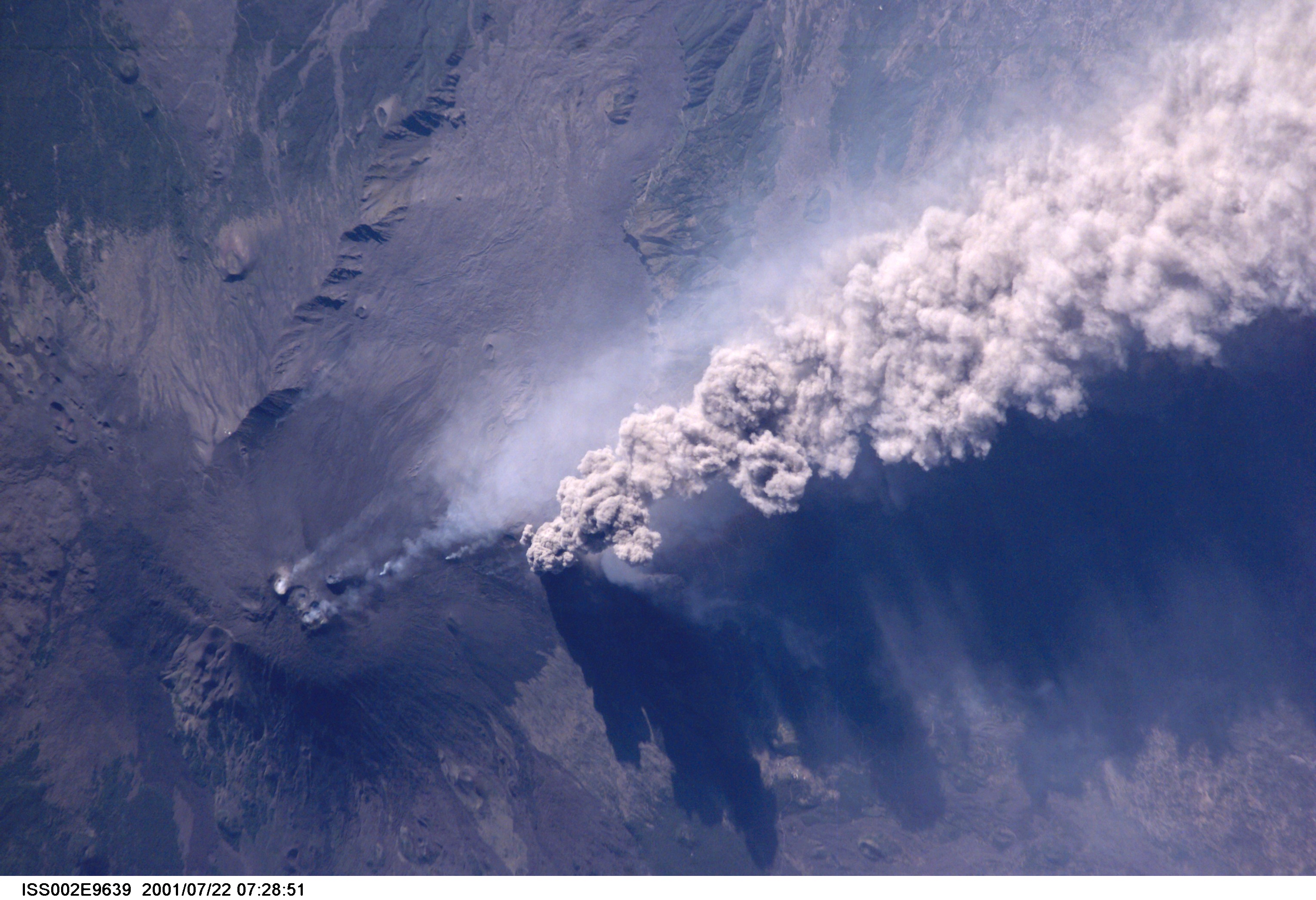 An overhead look at the smoke and ash being expelled from the erupting volcano Mt. Etna on the island of Sicily. This image was recorded by an Expedition Two crew member with a digital still camera.
