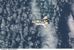 View of the Space Shuttle Discovery as it approaches the International Space Station (ISS) during the STS-105 mission. Aboard Discovery are the members of the Expedition Three crew - Frank L. Culbertson, Jr., mission commander, and cosmonauts Vladimir N. Dezhurov and Mikhail Tyurin, flight engineers - who will be replacing the Expedition Two crew that has been living on the ISS for the past five months. Visible in the payload bay of Discovery are the Multipurpose Logistics Module (MPLM) Leonardo which stores various supplies and experiments to be transferred into the ISS; and the Integrated Cargo Carrier (ICC), which carries the Early Ammonia Servicer (EAS) and two Materials International Space Station Experiment (MISSE) containers. This image was taken with a digital still camera.
