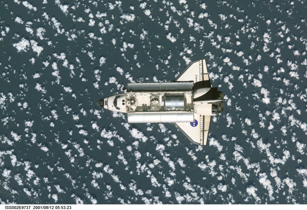 View of the Space Shuttle Discovery as it approaches the International Space Station (ISS) during the STS-105 mission. Aboard Discovery are the members of the Expedition Three crew - Frank L. Culbertson, Jr., mission commander, and cosmonauts Vladimir N. Dezhurov and Mikhail Tyurin, flight engineers - who will be replacing the Expedition Two crew that has been living on the ISS for the past five months. Visible in the payload bay of Discovery are the Multipurpose Logistics Module (MPLM) Leonardo, which stores various supplies and experiments to be transferred into the ISS; and the Integrated Cargo Carrier (ICC), which carries the Early Ammonia Servicer (EAS) and two Materials International Space Station Experiment (MISSE) containers. This image was taken with a digital still camera.