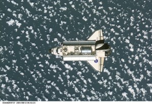 View of the Space Shuttle Discovery as it approaches the International Space Station (ISS) during the STS-105 mission. Aboard Discovery are the members of the Expedition Three crew - Frank L. Culbertson, Jr., mission commander, and cosmonauts Vladimir N. Dezhurov and Mikhail Tyurin, flight engineers - who will be replacing the Expedition Two crew that has been living on the ISS for the past five months. Visible in the payload bay of Discovery are the Multipurpose Logistics Module (MPLM) Leonardo, which stores various supplies and experiments to be transferred into the ISS; and the Integrated Cargo Carrier (ICC), which carries the Early Ammonia Servicer (EAS) and two Materials International Space Station Experiment (MISSE) containers. This image was taken with a digital still camera.