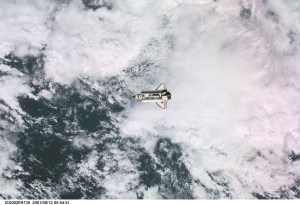 View of the Space Shuttle Discovery as it approaches the International Space Station (ISS) during the STS-105 mission. Aboard Discovery are the members of the Expedition Three crew - Frank L. Culbertson, Jr., mission commander, and cosmonauts Vladimir N. Dezhurov and Mikhail Tyurin, flight engineers - who will be replacing the Expedition Two crew that has been living on the ISS for the past five months. Visible in the payload bay of Discovery are the Multipurpose Logistics Module (MPLM) Leonardo, which stores various supplies and experiments to be transferred into the ISS; and the Integrated Cargo Carrier (ICC), which carries the Early Ammonia Servicer (EAS) and two Materials International Space Station Experiment (MISSE) containers. This image was taken with a digital still camera.