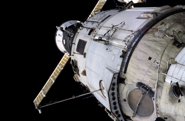 Backdropped by the blackness of space, a close-up exterior view of the International Space Station (ISS) shows a Progress supply vehicle docked to the Zvezda Service Module.