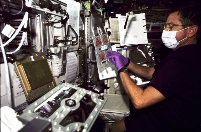 Astronaut Frank L. Culbertson, Jr., Expedition Three mission commander, works at the Biotechnology Specimen Temperature Controller (BSTC) for the Cellular Biotechnology Operations Support System (CBOSS) in the Destiny laboratory on the International Space Station (ISS).