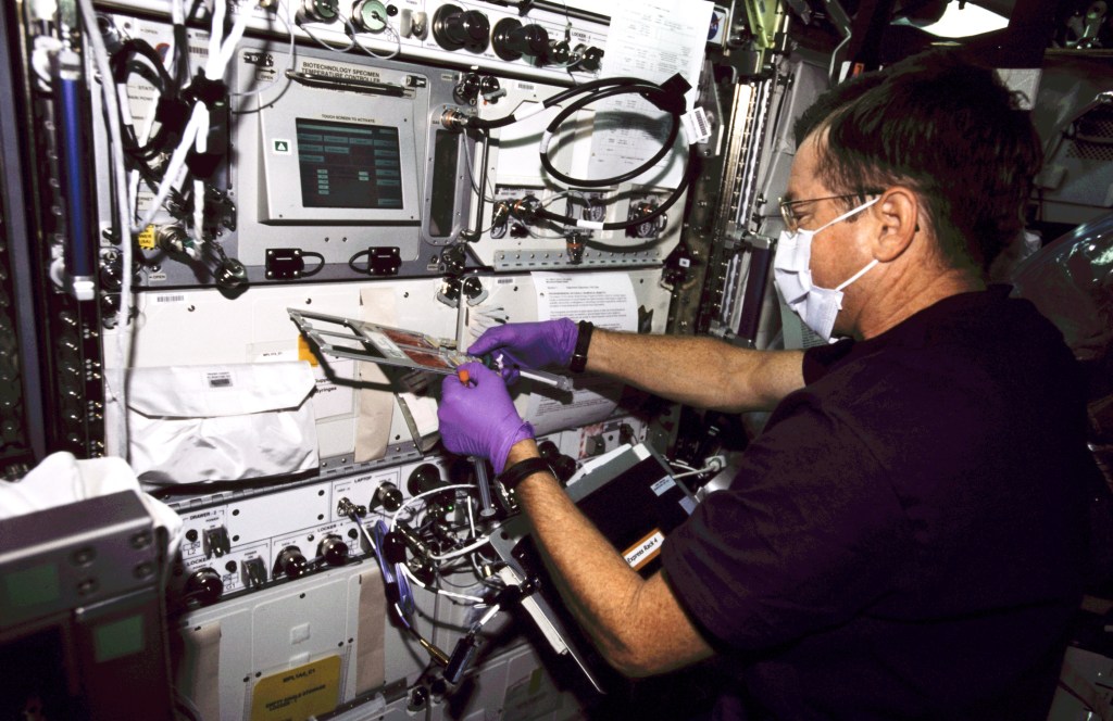 Astronaut Frank L. Culbertson, Jr., Expedition Three mission commander, works at the Biotechnology Specimen Temperature Controller (BSTC) for the Cellular Biotechnology Operations Support System (CBOSS) in the Destiny laboratory on the International Space Station (ISS).
