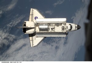 The Space Shuttle Discovery approaches the International Space Station (ISS) during the STS-105 mission. Aboard Discovery are the members of the Expedition Three crew -- Frank L. Culbertson, mission commander, and cosmonauts Vladimir N. Dezhurov and Mikhail Tyurin, flight engineers -- who will be replacing the Expedition Two crew that has been living on the ISS for the past five months. This image was taken by an Expedition Two crew member with a digital still camera.
