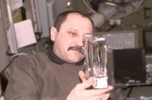 Yury V. Usachev of Rosaviakosmos, Expedition Two mission commander, examines a plant experiment in the Zvezda Service Module. This image was taken with a digital still camera.