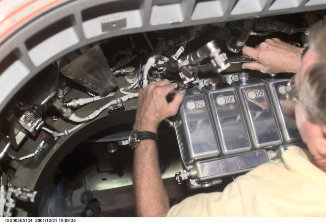 Frank L. Culbertson, Expedition Three mission commander, works on a Controller Power Assembly (CPA) in a hatchway on Unity Node 1. This image was taken with a digital still camera.