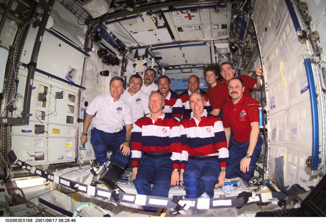The Expedition Three (white shirts), STS-105 (striped shirts), and Expedition Two (red shirts) crews assemble for a group photo in the Destiny laboratory on the International Space Station (ISS). The Expedition Three crew members are, from front to back, Frank L. Culbertson, Jr., mission commander; and cosmonauts Vladimir N. Dezhurov and Mikhail Tyurin, flight engineers; STS-105 crew members are, front row, Patrick G. Forrester and Daniel T. Barry, mission specialists, and back row, Scott J. Horowitz, commander, and Frederick W. (Rick) Sturckow, pilot; Expedition Two crew members are, from front to back, cosmonaut Yury V. Usachev, mission commander, James S. Voss and Susan J. Helms, flight engineers. Dezhurov, Tyurin and Usachev represent Rosaviakosmos. This image was taken with a digital still camera.