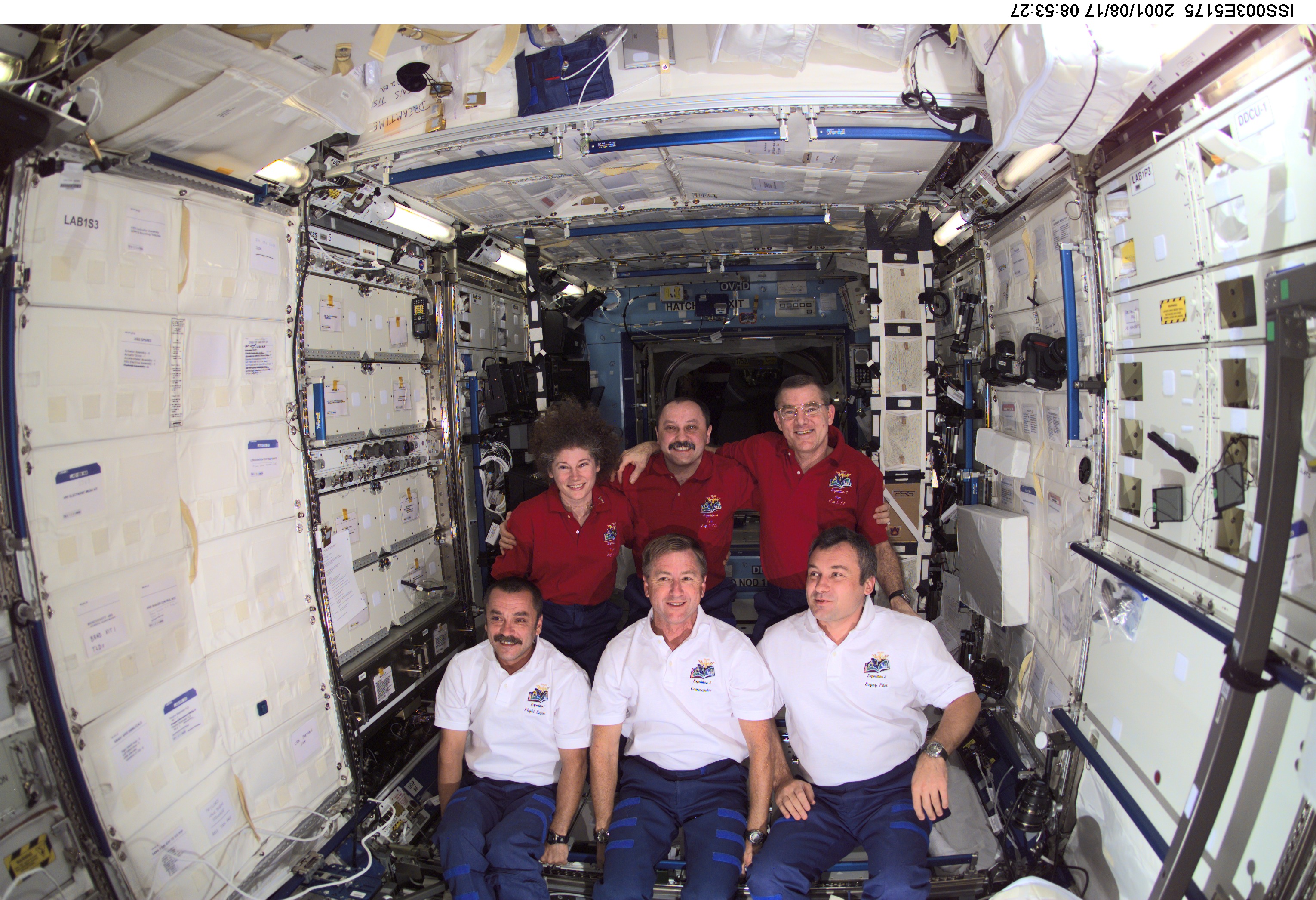 The Expedition Two (back row) and Expedition Three crews assemble for a group photo in the Destiny laboratory on the International Space Station (ISS). The Expedition Two crew members are, from left to right, Susan J. Helms, flight engineer, cosmonaut Yury V. Usachev, mission commander, and James S. Voss, flight engineer. The Expedition Three crew members are, from left to right, cosmonaut Mikhail Tyurin, flight engineer, Frank L. Culbertson, Jr., mission commander, and cosmonaut Vladimir N. Dezhurov, flight engineer. Dezhurov, Tyurin and Usachev represent Rosaviakosmos. This image was taken with a digital still camera.