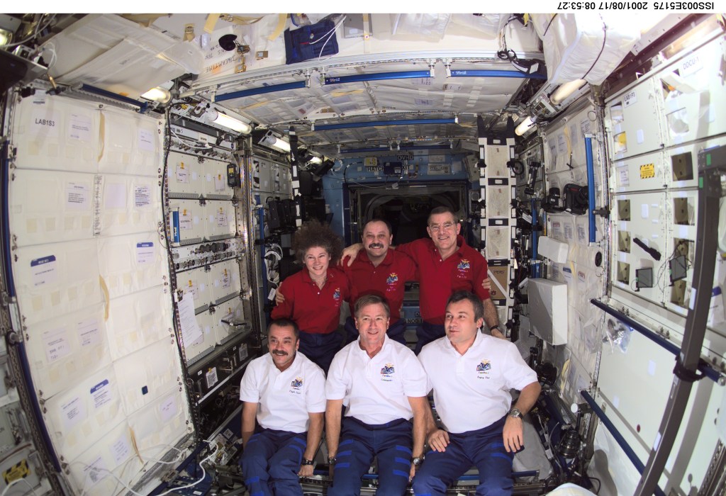 The Expedition Two (back row) and Expedition Three crews assemble for a group photo in the Destiny laboratory on the International Space Station (ISS). The Expedition Two crew members are, from left to right, Susan J. Helms, flight engineer, cosmonaut Yury V. Usachev, mission commander, and James S. Voss, flight engineer. The Expedition Three crew members are, from left to right, cosmonaut Mikhail Tyurin, flight engineer, Frank L. Culbertson, Jr., mission commander, and cosmonaut Vladimir N. Dezhurov, flight engineer. Dezhurov, Tyurin and Usachev represent Rosaviakosmos. This image was taken with a digital still camera.