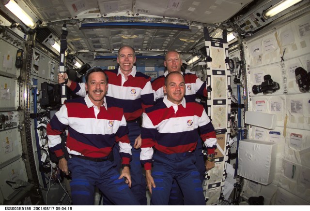 Astronauts Scott J. Horowitz (bottom left), STS-105 mission commander, Frederick W. (Rick) Sturckow, pilot, Daniel T. Barry (top left), and Patrick G. Forrester, both mission specialists, pause from their daily activities to pose for this photo in the Destiny laboratory while visiting the International Space Station (ISS). This image was taken with a digital still camera.
