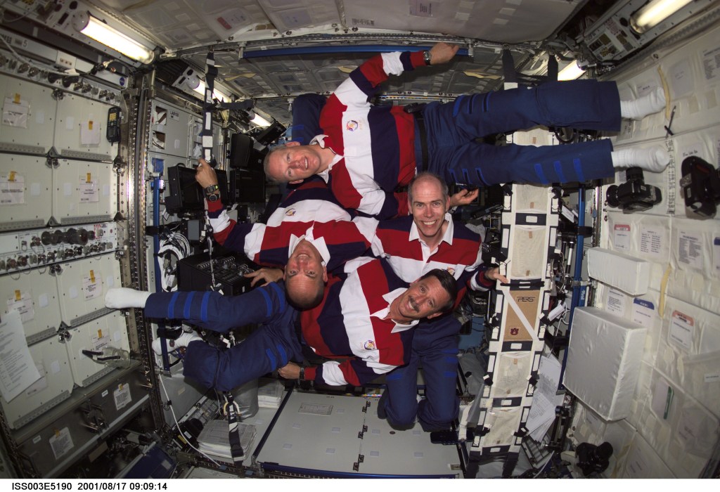 The STS-105 crew members pause for this group photo in the Destiny laboratory on the International Space Station (ISS). Clockwise from bottom are, Scott J. Horowitz and Frederick W. (Rick) Sturckow, mission commander and pilot, respectively, Patrick G. Forrester and Daniel T. Barry, both mission specialists. This image was taken with a digital still camera.