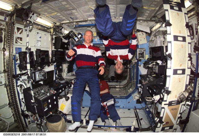 Astronauts Patrick G. Forrester (left) and Daniel T. Barry, both STS-105 mission specialists, pause from their daily activities to pose for this photo taken in the Destiny laboratory on the International Space Station (ISS). This image was taken with a digital still camera.