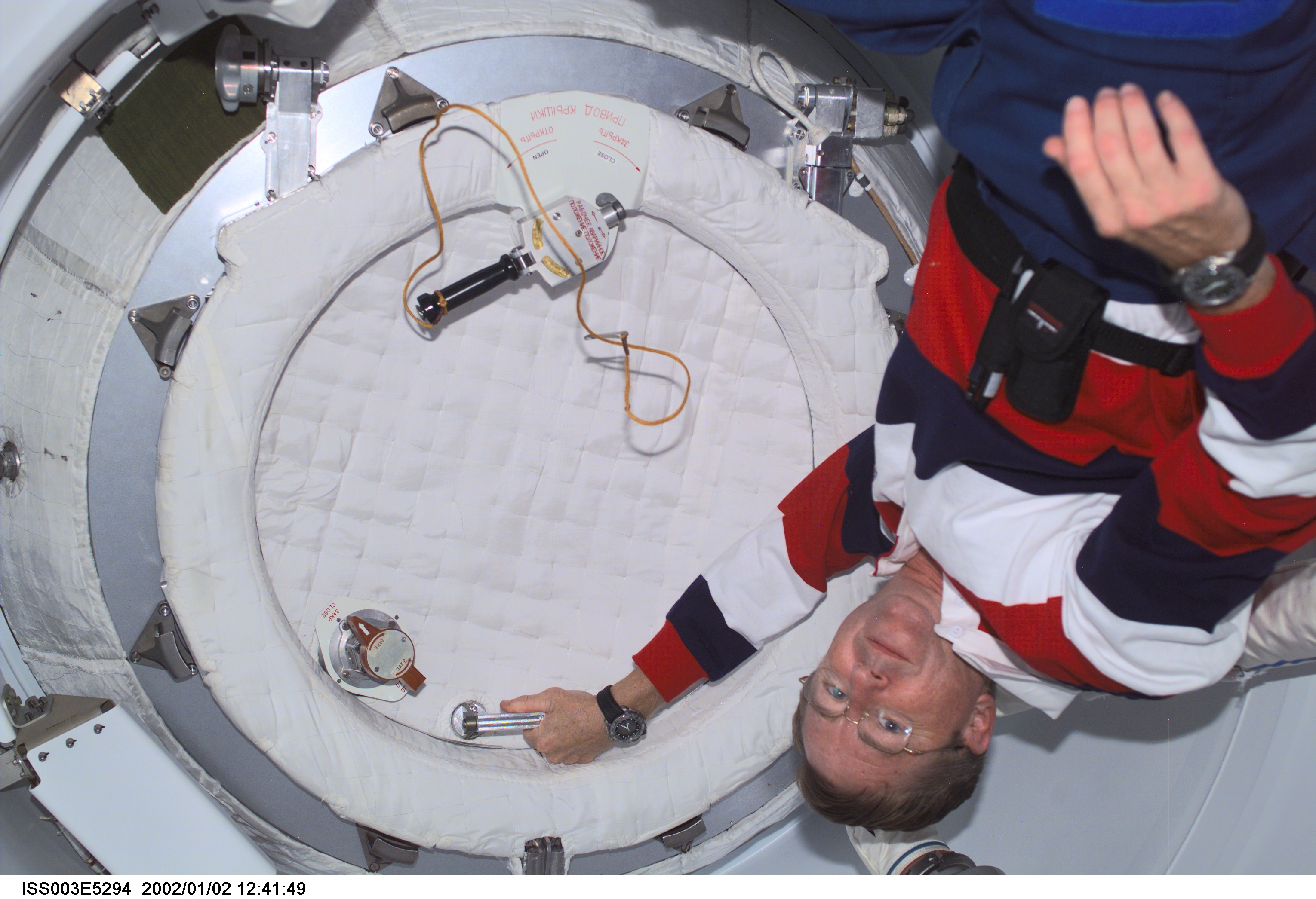 Astronaut Frank L. Culbertson, Jr., Expedition Three commander, closes the hatch in the Pressurized Mating Adapter (PMA2) on the International Space Station (ISS) prior to the separation of the station and the Space Shuttle Discovery. This image was taken with a digital still camera.