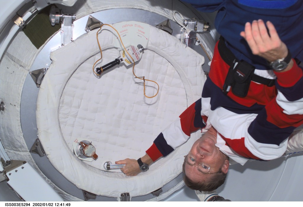 Astronaut Frank L. Culbertson, Jr., Expedition Three commander, closes the hatch in the Pressurized Mating Adapter (PMA2) on the International Space Station (ISS) prior to the separation of the station and the Space Shuttle Discovery. This image was taken with a digital still camera.