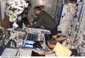 Astronaut Frank L. Culbertson, Jr. (bottom), Expedition Three commander, and cosmonaut Vladimir N. Dezhurov, flight engineer representing Rosaviakosmos, perform routine tasks in the Destiny laboratory on the International Space Station (ISS). This image was taken with a digital still camera.
