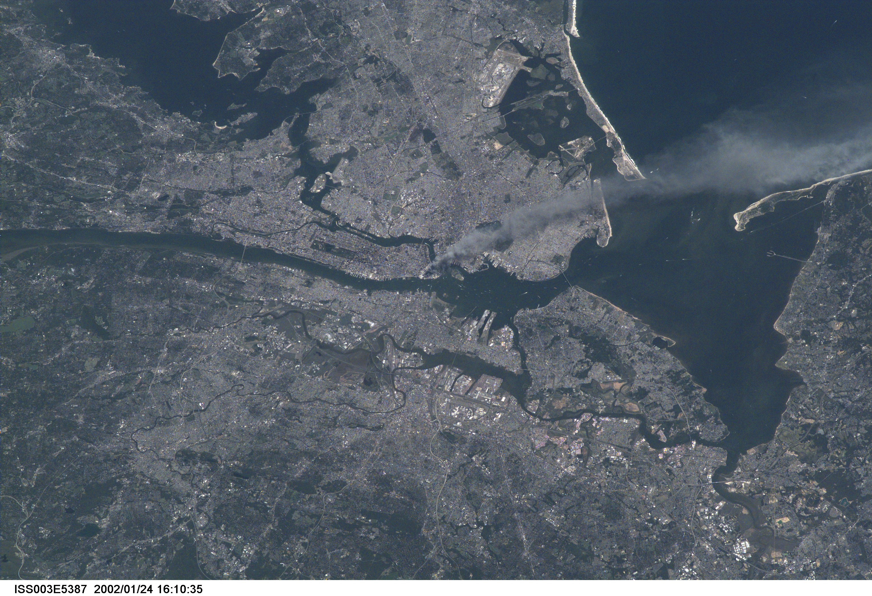 One of a series of pictures taken of metropolitan New York City (and other parts of New York as well as New Jersey) by one of the Expedition Three crew members onboard the International Space Station (ISS) at various times during the day of September 11, 2001. The image shows a smoke plume rising from the Manhattan area. The orbital outpost was flying at an altitude of approximately 250 miles. The image was recorded with a digital still camera. Please note: The date identifiers on some frames (other than those that indicate Sept. 11, 2001) are not accurate due to a technical problem with one of the Expedition Three cameras.