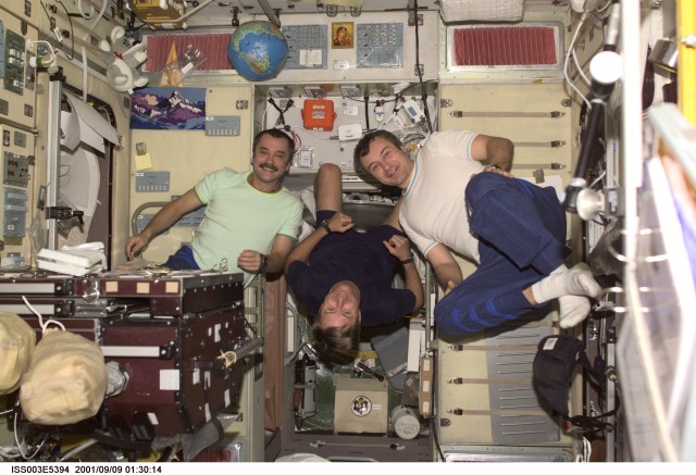 The Expedition Three crewmembers assemble for a crew photo in the Zvezda Service Module (SM) of the International Space Station (ISS). Astronaut Frank L. Culbertson, Jr. (center) is the Expedition Three commander. He is flanked by cosmonauts Mikhail Tyurin (left) and Vladimir Dezhurov, both flight engineers representing Rosaviakosmos. This picture was taken with a digital still camera.